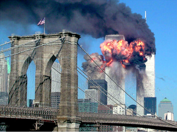 The second tower of the World Trade Center bursts into flames after being hit by a hijacked airplane.